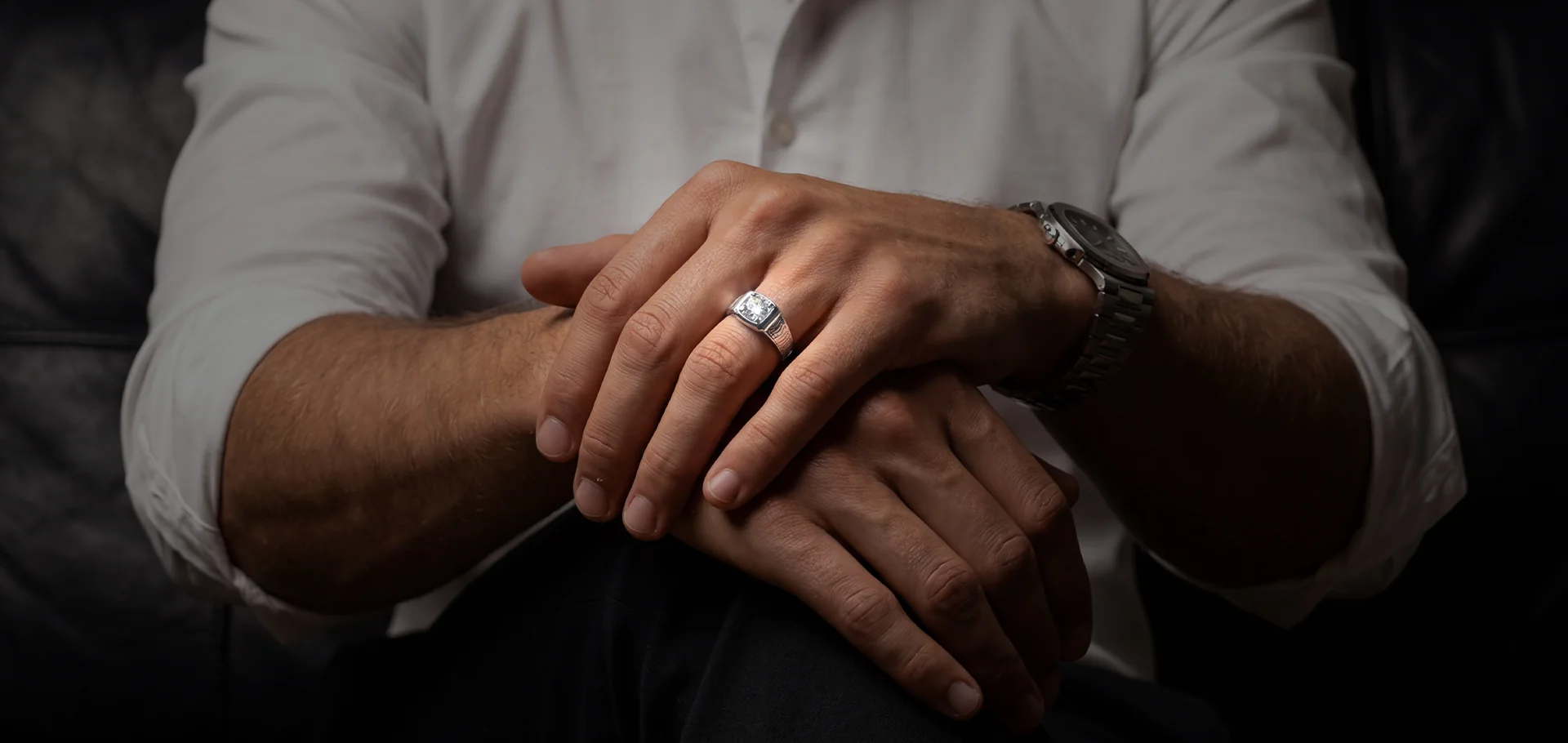 A men's diamond ring from Lineage on folded hands
