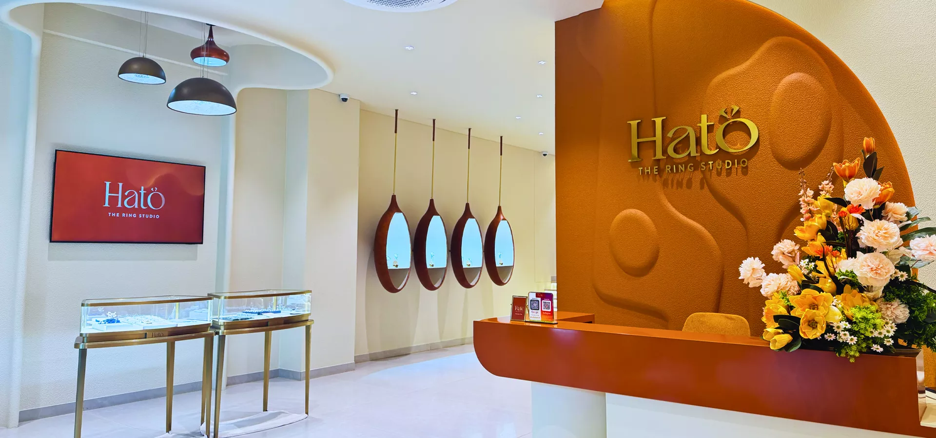 Inside the HATO studio in Indiranagar — terracotta sculpted wall, brass vitrines and oval mirrors